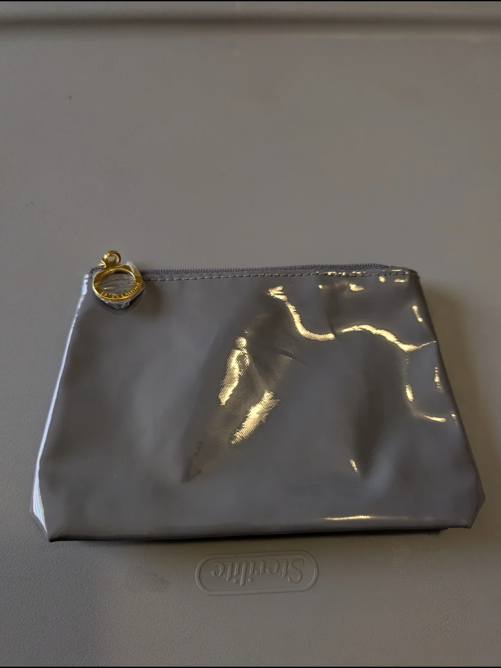 Estee Lauder grey patent makeup bag gold zipper pull pouch women